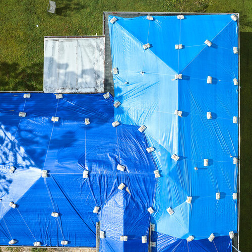 emergency roofing repairs, a tarped roof